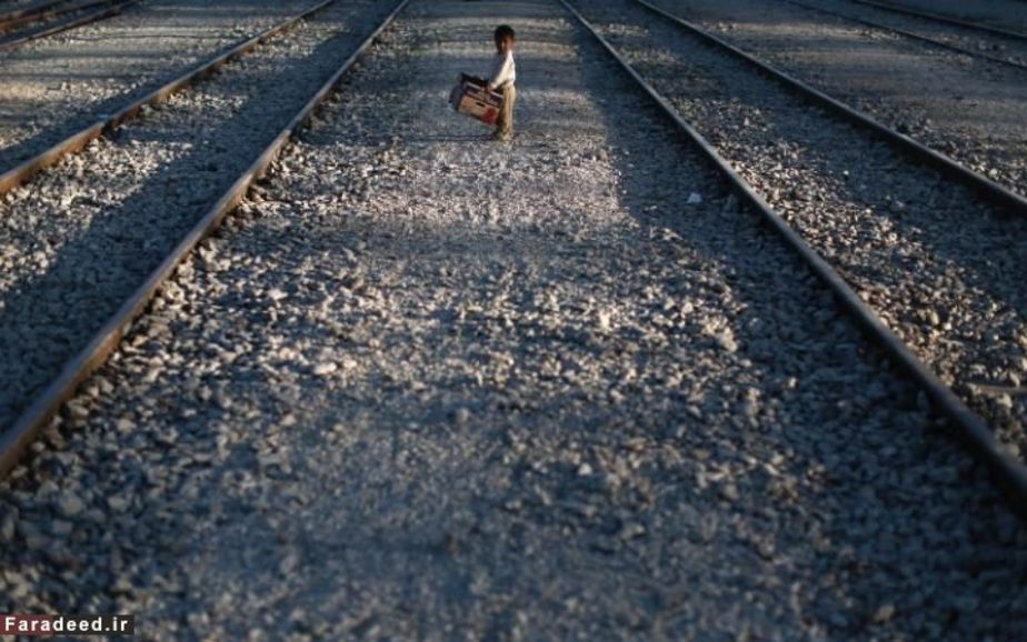 کودک مهاجر روی ریل راه‌آهن در اردوگاه پناهندگان در ایدومنی