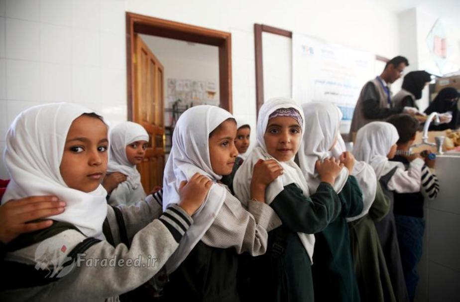 دختران یمنی یک مدرسه در صنعا، به صف ایستاده اند تا از یک خیریه ی محلی غذای رایگان دریافت کنند. 
